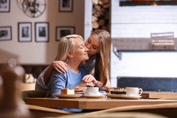 Mother and her adult daughter spending time together in cafe