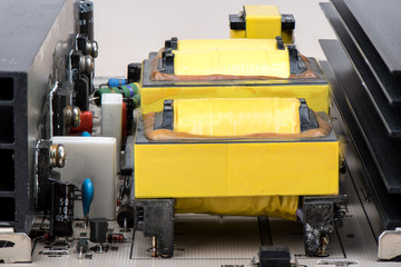 A number of yellow transformers and other electronic elements.