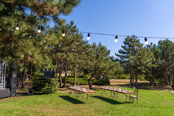 Preparing for an open-air party. Decorated served tables await guests. Decoration Details
