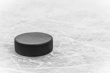 hockey puck lies on the snow close-up