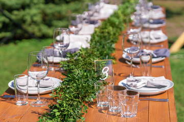 Preparing for an open-air party. Decorated with fresh flowers served tables. Table number. Decoration Details