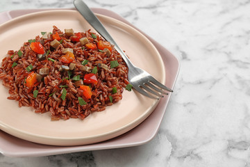 Tasty brown rice on marble table, closeup