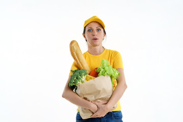 Tired delivery woman in yellow posing with grocery bag, white background