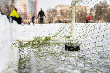 hockey puck in the goal net close-up