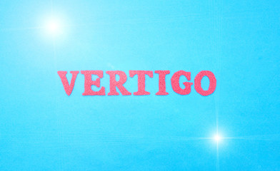 Word vertigo in red letters on a blue background. The concept of medical disease of weakness and...