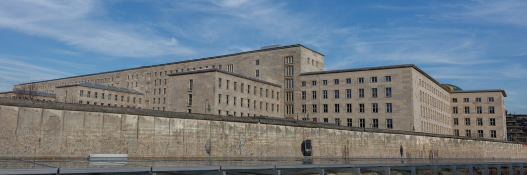 BERLIN, GERMANY - January 12, 2020: Panorama of Bundesministerium der Finanzen (federal ministry of finance). The building has a national socialist history. Remains of Berlin Wall in the foreground. 