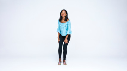 Young woman standing against white background