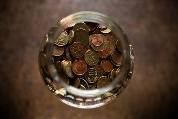 Glas mit  Euro und Pfenninge in Münzen gespart