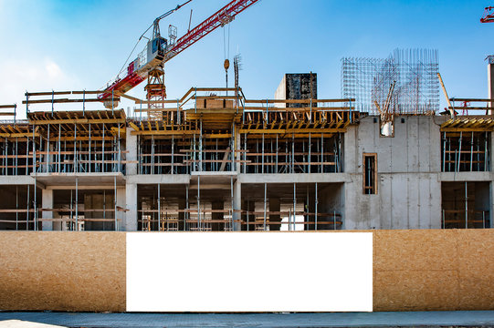 Blank white banner for advertisement on a fence of a building under construction