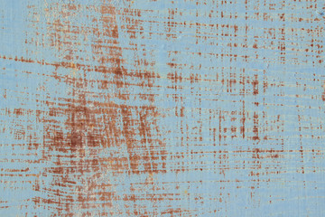 Rusty wall with old paint for the backdrop. The primary color is Rock Blue. Stripes, texture, scratches.