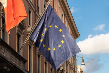 European flag waving with the cloudy blue sky