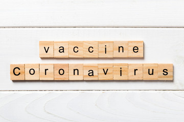 coronavirus vaccine word written on wood block. text on wooden table for your desing, Wuhan...