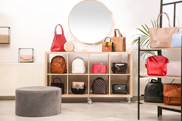Collection of stylish woman's bags in modern store