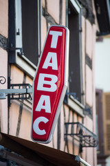 closeup of red tabacco sign with french text tabac, the traduction in english of tobacco
