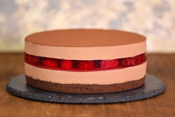 Delicious chocolate mousse cake with raspberries jelly.