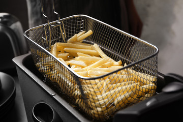 Cooking delicious french fries in hot oil