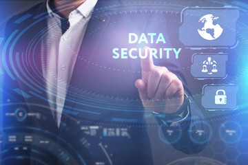 Business, Technology, Internet and network concept. Young businessman working on a virtual screen of the future and sees the inscription: Data security