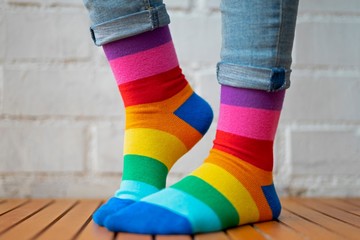 Feet with colored socks on a white background.