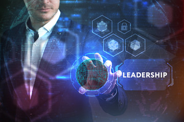 Business, Technology, Internet and network concept. Young businessman working on a virtual screen of the future and sees the inscription: Leadership