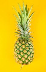 Fresh pineapple isolated on yellow background.