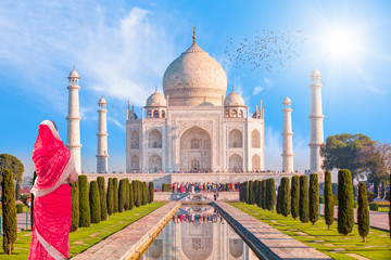Taj Mahal, Agra, India - Young woman in traditional red clothes