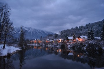 Fototapeta premium View from the river of Snowy Bad Goisern at dusk. Hallstatt, Austria.
