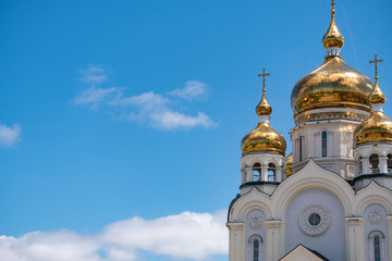Fototapeta na wymiar Khabarovsk, Russia - Jun 15, 2019: Spaso-Preobrazhensky Cathedral in Khabarovsk on the background of blue cloudy sky.