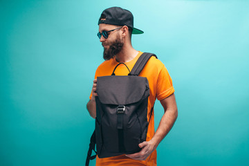 Handsome bearded hipster guy with black casual backpack, with space for your logo or design. Mockup...