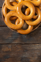 Bagels with poppy seeds on a white ceramic plate on the gray kitchen table. Homemade cake. Top view with a copy of the space
