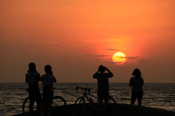 Fototapeta na wymiar The silhouette of the cyclist at sunrise