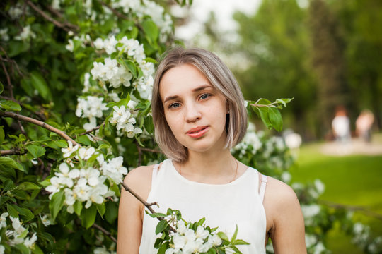 Cute young teen woman outdoor. Healthy girl in flowers garden