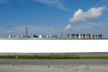 Blank white billboard/banner for advertisement on the fence of construction site