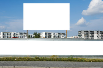 Blank white billboard/banner for advertisement on the fence of construction site © diesirae