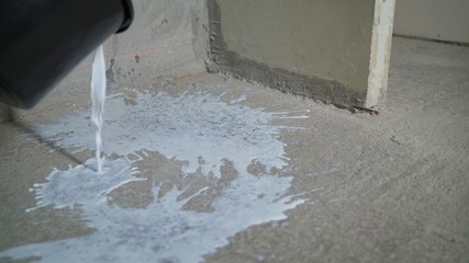 Priming floor. Contract painter painting garage floor to speed up selling of home