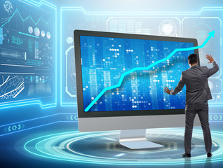 Businessman in economic forecasting concept with charts
