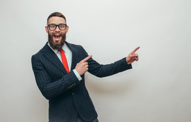 Handsome businessman with beard in trendy formal suit pointing with fingers at your text. Crazy hipster guy emotions. Discount, sale, season sales.