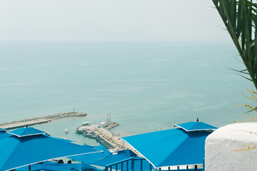 Obraz premium A small harbor with sailboats in the Mediterranean Sea in the city of Sidi Bou Said near Tunisia