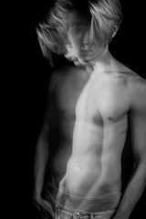 Dreamy artistic long exposure portrait of sporty man with naked torso. looking judging. emotions and anxiety. psychological concept photo. Black and white series of creative works