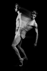 Fototapeta na wymiar athletic dancer black and white. Long exposure creative original technique emotions and anxiety. contemporary art dance. double personality emotional photo