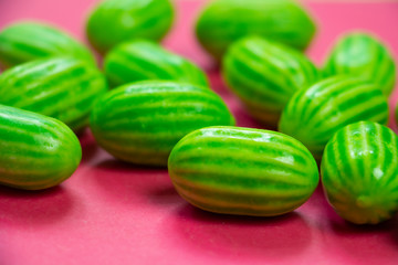 Summer colorful pink background with green melon sweets