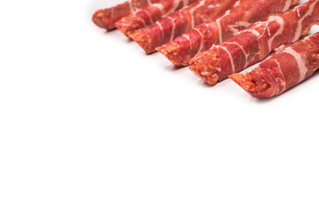 Chevapchichi in bacon isolated on white background.