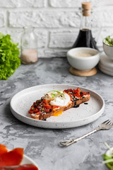 Sandwich with red fish, poached egg, balsamic vinegar and micro-greens