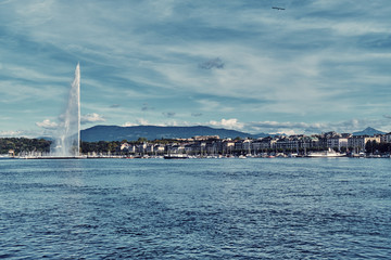 Cityscape with fountain and lake in Geneva.