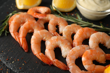 Composition with delicious shrimps on black background, close up