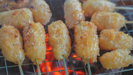 Khao jee: a street style Thai style grill sticky rice, with egg paste. a grill shot for experience on the charcoal turtle.