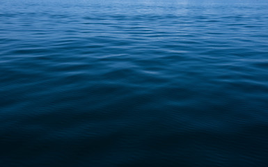 Blue water background with ripples Sea low angle view, Ocean, Wave.   Travel destination and nature environment concept - Ocean water surface texture, summer holiday background