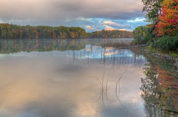 Autumn landscape of the shoreline of Moccasin Lake with reflections in calm water, Hiawatha National Forest, Michigan's Upper Peninsula, USA