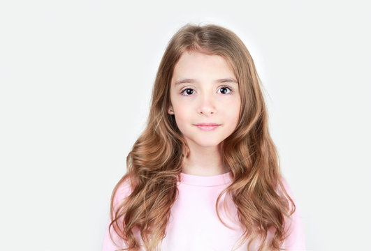 Beautiful long hair smiling face caucasian child girl teen age closeup portrait.