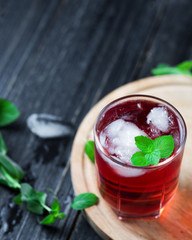 Summer refreshing red cocktail with ice, mint, gin