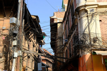A whirl of electric cables over a street in Bhaktapur city, Nepal